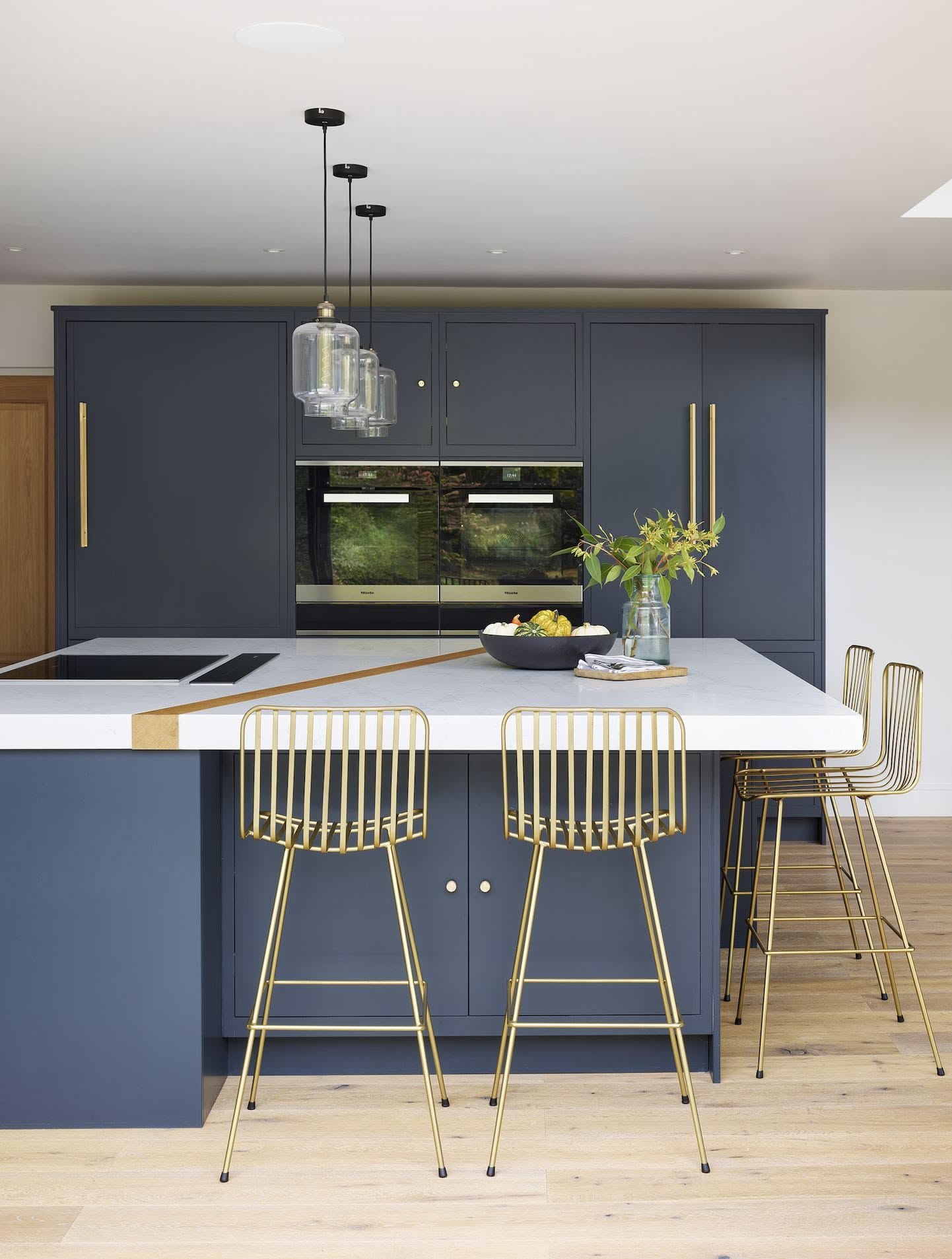 blue flat-panel cabinets paired with brass hardware