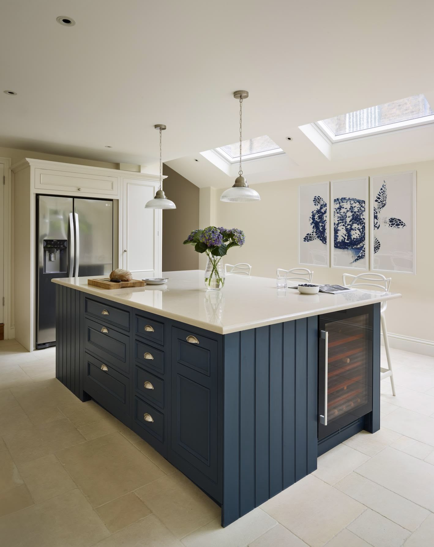 Open-plan kitchen and dining featuring a deep blue island