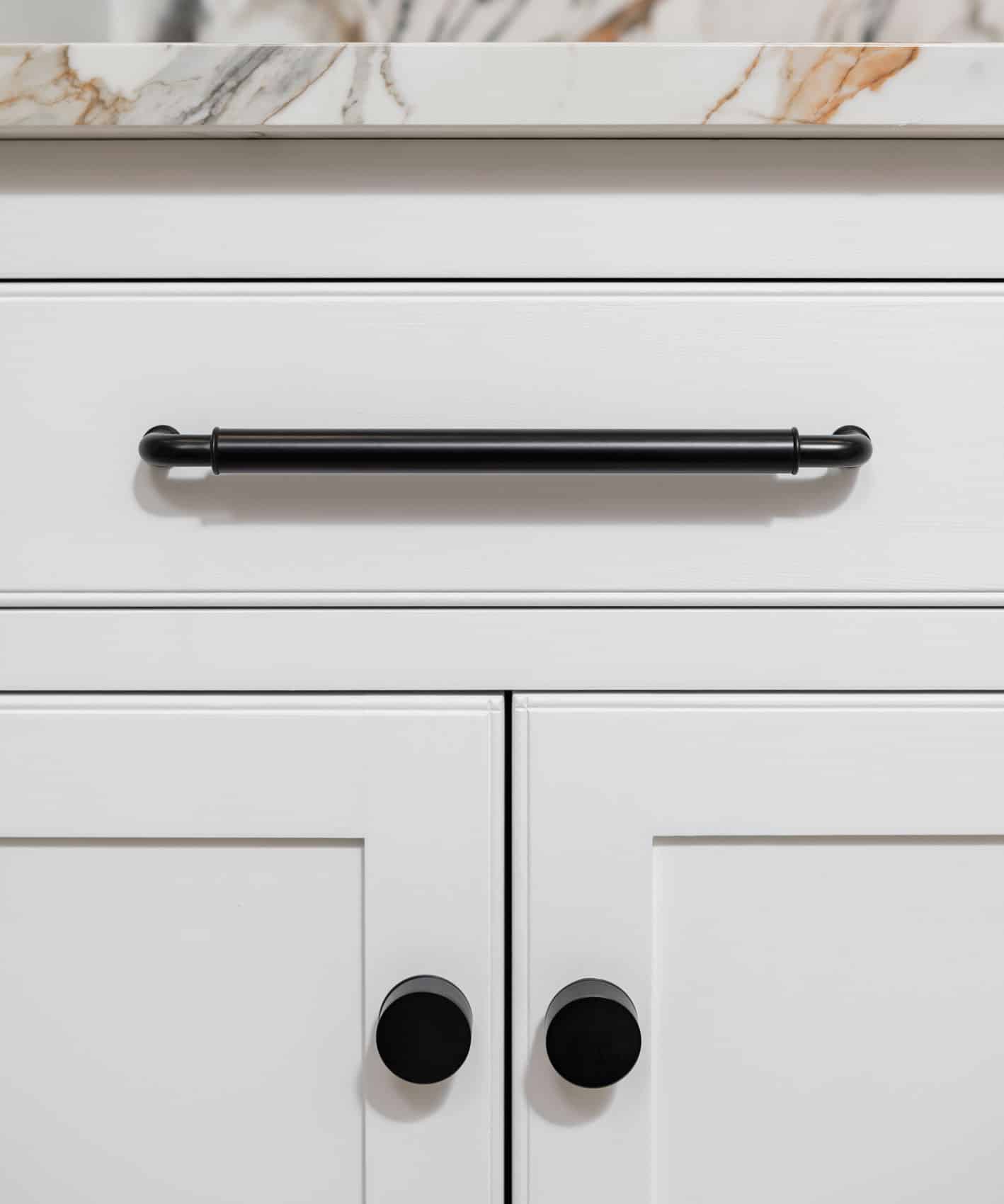 Closeup of white Arbor cabinetry featuring black handles