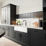 Black cabinetry in a monochrome kitchen setting