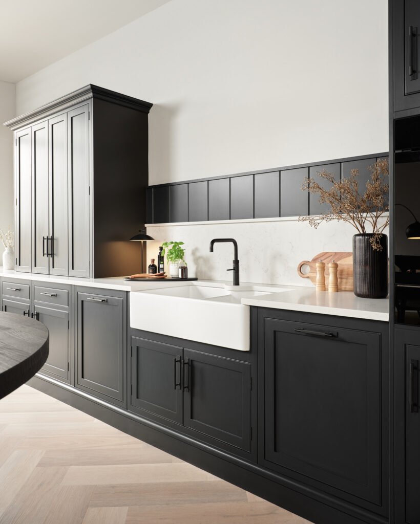 Black cabinetry in a monochrome kitchen setting